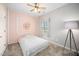 Cozy bedroom featuring a bed, accent wall, and a large window with natural light at 8300 Neuse Hunter Dr, Raleigh, NC 27616