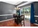 Dining area with a dark table set, modern chandelier, and sliding glass doors to the backyard at 8300 Neuse Hunter Dr, Raleigh, NC 27616