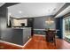 Dining area adjacent to the kitchen, featuring a modern chandelier and sliding glass doors with blue curtains at 8300 Neuse Hunter Dr, Raleigh, NC 27616