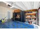 Spacious garage with blue and black tiled floor and black storage cabinets and shelving along the walls at 8300 Neuse Hunter Dr, Raleigh, NC 27616
