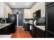 Well-lit kitchen featuring updated cabinetry, modern appliances, and dark backsplash at 8300 Neuse Hunter Dr, Raleigh, NC 27616