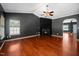 Living room with fireplace, hardwood floors, large windows and an open archway to another room at 8300 Neuse Hunter Dr, Raleigh, NC 27616