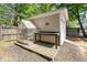 View of the shed, greenhouse, wooden deck, and wood chip perimeter in the backyard at 8300 Neuse Hunter Dr, Raleigh, NC 27616