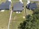 Aerial view of fenced backyard with patio featuring outdoor dining furniture and a fire pit at 86 Buckhaven Ct, Holly Springs, NC 27540