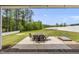 Well-maintained backyard features a patio, a dining set, and a fully fenced yard at 86 Buckhaven Ct, Holly Springs, NC 27540