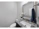 Charming powder room featuring a granite vanity and decorative mirror at 86 Buckhaven Ct, Holly Springs, NC 27540