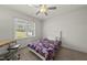Comfortable bedroom with natural light, desk, and ceiling fan at 86 Buckhaven Ct, Holly Springs, NC 27540