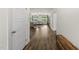 Hallway with hardwood floors leading to an open-concept living area with lots of natural light at 86 Buckhaven Ct, Holly Springs, NC 27540
