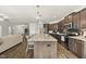 Modern kitchen featuring stainless steel appliances, a center island, and hardwood floors at 86 Buckhaven Ct, Holly Springs, NC 27540