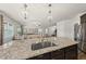 Open-concept kitchen with granite countertops, pendant lighting, and stainless steel appliances at 86 Buckhaven Ct, Holly Springs, NC 27540