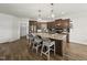 Well-equipped kitchen with hardwood floors, granite countertops, and a center island with seating at 86 Buckhaven Ct, Holly Springs, NC 27540