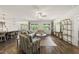 Open-concept living room with hardwood floors, modern furniture, and great natural light at 86 Buckhaven Ct, Holly Springs, NC 27540