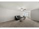 Spacious living room with plush carpet, cozy seating, and a ceiling fan for comfortable living at 86 Buckhaven Ct, Holly Springs, NC 27540