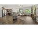 Open-concept living and kitchen area with hardwood floors, a center island, and modern furniture at 86 Buckhaven Ct, Holly Springs, NC 27540