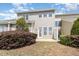 Exterior backyard featuring neutral siding, a small patio, shrubs, and trimmed bushes at 9207 Wooden Rd, Raleigh, NC 27617
