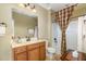 Cozy bathroom with a combined tub and shower, vanity with sink, and neutral decor at 9207 Wooden Rd, Raleigh, NC 27617