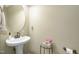 Powder room featuring a pedestal sink, decorative accents and neutral paint at 9207 Wooden Rd, Raleigh, NC 27617