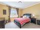 Bright bedroom featuring a large window, comfortable bed, and matching nightstands with lamps at 9207 Wooden Rd, Raleigh, NC 27617