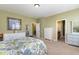 Bedroom with light-colored walls, large windows, and an ensuite bathroom at 9207 Wooden Rd, Raleigh, NC 27617