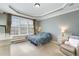 Bedroom with large windows, neutral carpet, recessed lighting, and decorative tray ceiling at 9207 Wooden Rd, Raleigh, NC 27617