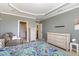 Bright primary bedroom with a tray ceiling, neutral walls, and large dressers at 9207 Wooden Rd, Raleigh, NC 27617
