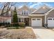 Charming brick and vinyl two-story home with well-maintained landscaping and attached two-car garage at 9207 Wooden Rd, Raleigh, NC 27617
