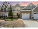 Charming brick and vinyl two-story home with well-maintained landscaping and attached two-car garage at 9207 Wooden Rd, Raleigh, NC 27617