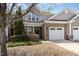 Charming brick and vinyl two-story home with well-maintained landscaping and attached two-car garage at 9207 Wooden Rd, Raleigh, NC 27617