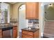 Kitchen featuring warm wood cabinetry, granite counters, and stainless steel dishwasher at 9207 Wooden Rd, Raleigh, NC 27617