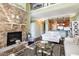 Bright living room featuring a stone fireplace, neutral furniture, and an open floor plan at 9207 Wooden Rd, Raleigh, NC 27617