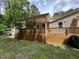 Spacious wooden back deck with a covered area perfect for outdoor entertaining and relaxation at 10017 Oakley Rd, Zebulon, NC 27597