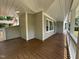 Charming covered porch features stained wood flooring, creating a welcoming outdoor living space at 10017 Oakley Rd, Zebulon, NC 27597