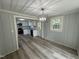 Dining room with a view into the modern white kitchen with stainless steel appliances and granite countertops at 10017 Oakley Rd, Zebulon, NC 27597