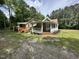 Charming cottage-style home with a covered porch and lush landscaping at 10017 Oakley Rd, Zebulon, NC 27597