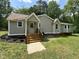 Attractive cottage-style home with a covered front porch and manicured landscaping at 10017 Oakley Rd, Zebulon, NC 27597