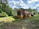 Cottage-style home featuring a covered deck and a lush green lawn at 10017 Oakley Rd, Zebulon, NC 27597