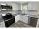 Updated kitchen featuring stainless steel appliances, granite countertops, and white subway tile backsplash at 10017 Oakley Rd, Zebulon, NC 27597