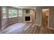 This living room has a decorative fireplace, built-in bookshelves, and light grey walls at 10017 Oakley Rd, Zebulon, NC 27597