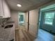 This pantry features overhead cabinets, granite countertops, and multiple doors leading into other rooms at 10017 Oakley Rd, Zebulon, NC 27597