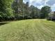 Lush yard with mature trees providing privacy and shade at 10017 Oakley Rd, Zebulon, NC 27597