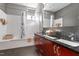 Bathroom boasts double sinks, dark tile floors, and a tub/shower combo at 101 Morris St # D, Durham, NC 27701