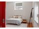 Cozy bedroom with large window, stylish lamps, and area rug at 101 Morris St # D, Durham, NC 27701
