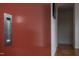 Close up of a modern, red pocket door with a sleek, recessed handle at 101 Morris St # D, Durham, NC 27701