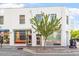 Street level view, displaying the building's facade, storefronts, and surrounding cityscape at 101 Morris St # D, Durham, NC 27701