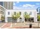 Street level view, presenting the building's facade with storefronts, greenery, and pedestrian access at 101 Morris St # D, Durham, NC 27701