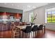 Spacious open kitchen features wood cabinets, island with seating, and bright natural light at 101 Morris St # D, Durham, NC 27701