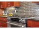 Gourmet kitchen with stainless steel oven and range, stylish backsplash, and sleek dark countertops at 101 Morris St # D, Durham, NC 27701