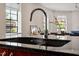 Elegant kitchen features stainless steel sink and dark granite countertops at 101 Morris St # D, Durham, NC 27701