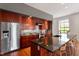 Bright kitchen with stainless steel appliances, wood cabinets, and center island at 101 Morris St # D, Durham, NC 27701