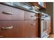 Close-up view of kitchen cabinets and stainless steel oven featuring dark countertops at 101 Morris St # D, Durham, NC 27701